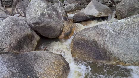 flowing water cascading over rocks and boulders at emerald creek falls