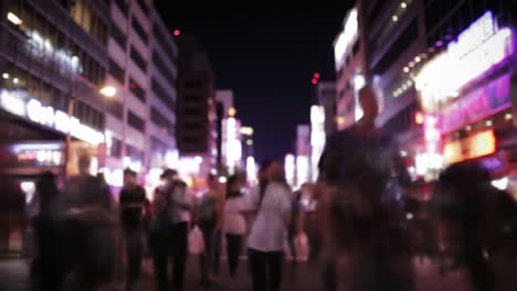 a bustling night scene in an urban setting: people walking through neon-lit streets amidst vibrant city energy and diverse crowds engaging in nightlife