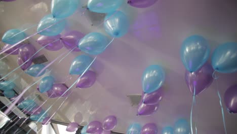 purple and blue balloons decorated ceiling