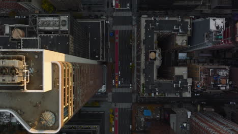 Aerial-birds-eye-overhead-top-down-view-of-cars-driving-in-streets-of-downtown.-Fly-above-high-rise-buildings.-Manhattan,-New-York-City,-USA