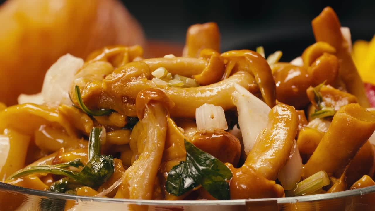 Close-up of fermented yellow honeydew mushrooms with onion in plate. Preservation of vegetables in glass jars. Fermentation preserved mushroom with spices.