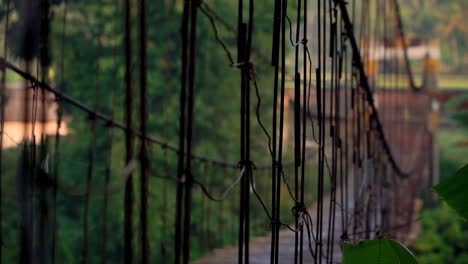 Wooden-suspension-bridge-is-swaying---Rural-view-of-Indonesian-countryside