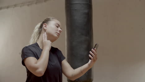 medium shot of woman taking her pulse rate before cardio workout