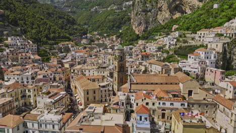 Amalfi-Italy-Aerial-v9-cinematic-reverse-flyover-away-from-Cathedral-of-Saint-Andrew,-reveals-picturesque-landscape-of-coastal-town-nested-within-mountain-valley---Shot-with-Mavic-3-Cine---May-2023