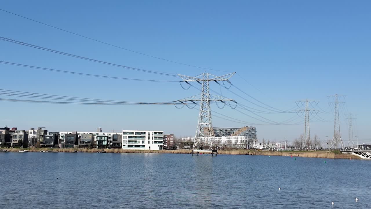Electricity pylon on the water in a modern urban area