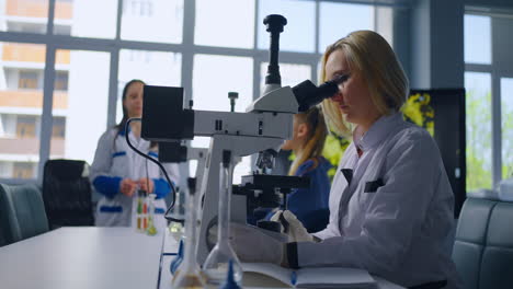 scientists working in a laboratory with microscopes