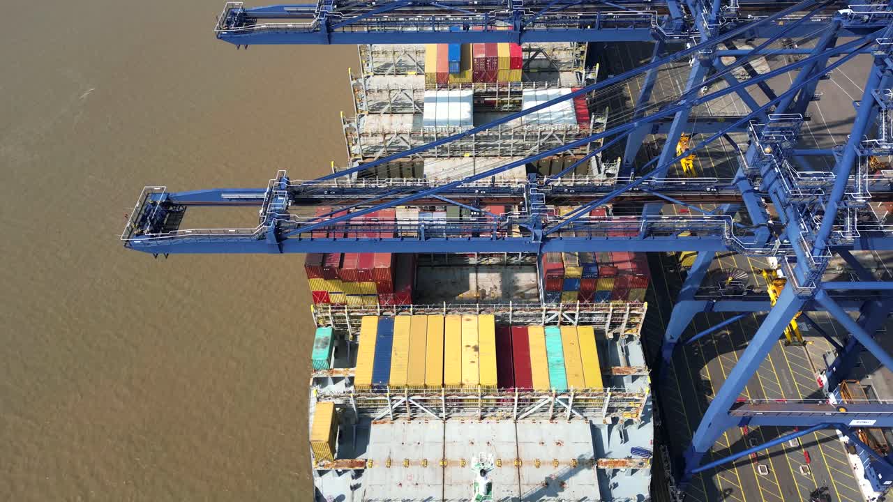 Aerial view from bow to stern looking down onto a container ship being unloaded at Felixstowe Container Port, UK