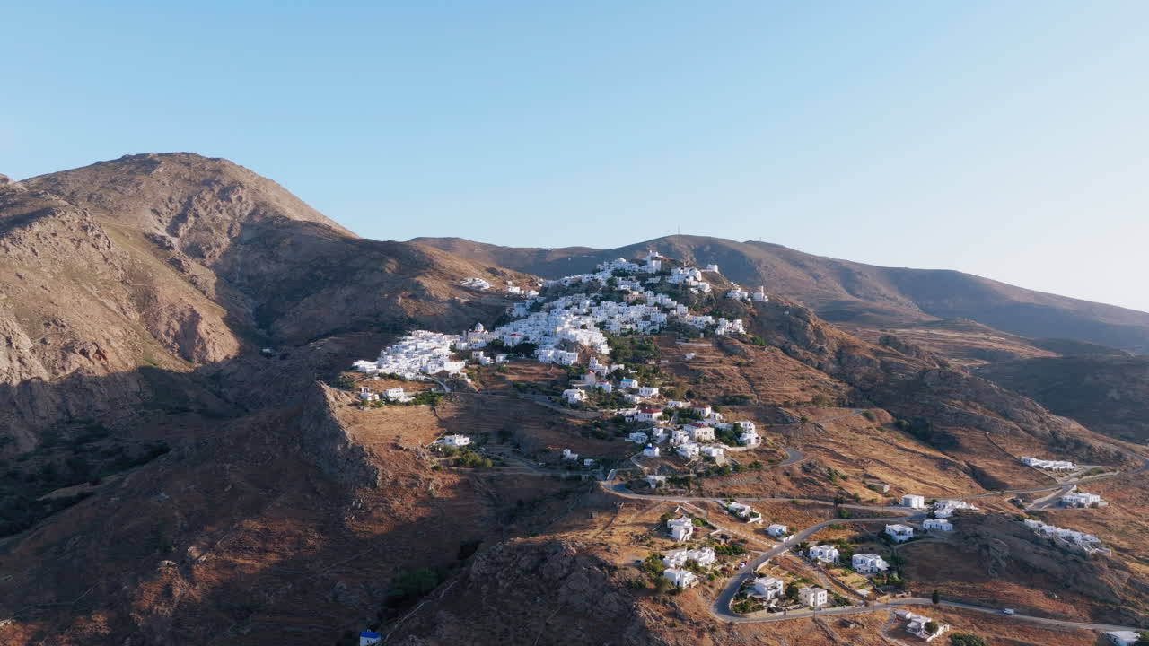 Morning sun illuminates Serifos Chora’s hilltop chapel and white houses in Cycladic style
