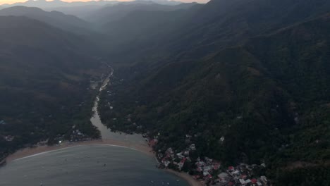 scenery of mountain ranges with dense forest in yelapa town, jalisco, mexico. aerial pullback shot