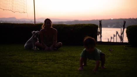happy latin baby boy walking on the grass having fun at dusk