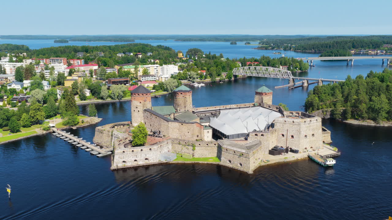 Panoramic drone shot around the Olafsborg Castle, sunny, summer day in Finland