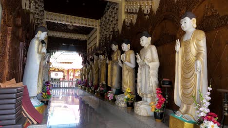 rows of religious artefacts and statues inside a buddhist temple in malaysia