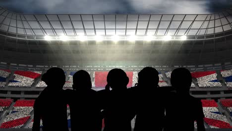 animation of silhouettes of team of sports women with british flag over sports stadium