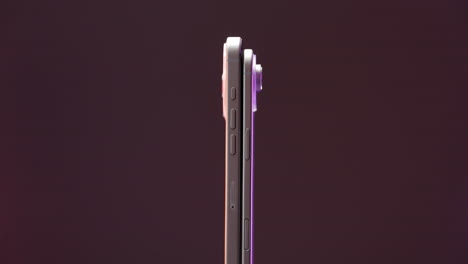 side view of two smartphones highlighting their slim profiles and buttons