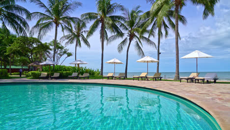 Beautiful-umbrella-and-chair-around-swimming-pool-in-hotel-and-resort---vacation-concept