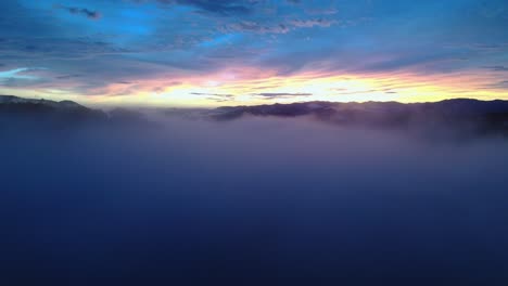 drone flythrough scenic blue sunset cloudscape with bright colorful horizon, 4k