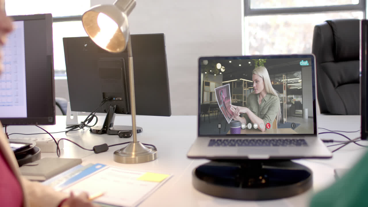 Laptop with video call with caucasian businesswoman on screen