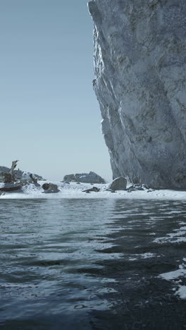 a view of a cliff overlooking a frozen ocean