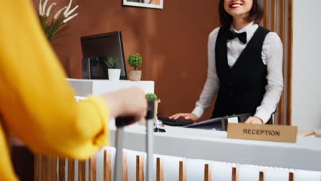 asian traveler asking receptionist about hotel facilities