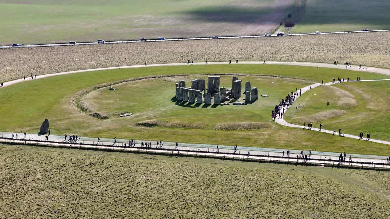 Long Panning drone aerial Stonehenge UK large numbers of visitors
