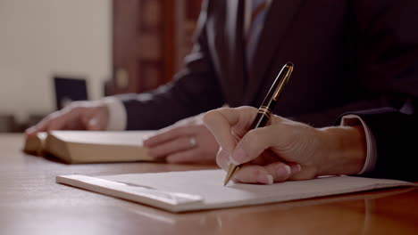 Female-Lawyer-Attorney-Taking-Meeting-Notes-on-a-Legal-Notepad---Cinematic-Rack-Focus-close-up-in-slow-motion