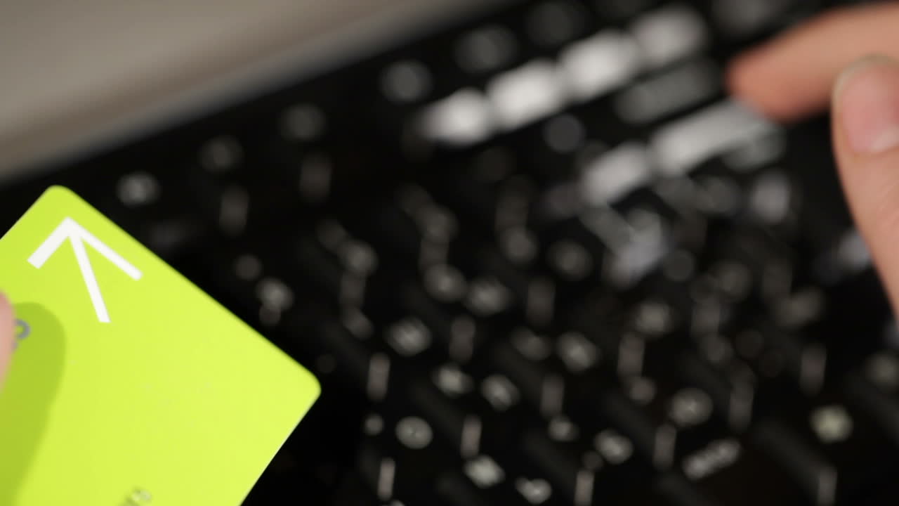 Holding a credit card and typing