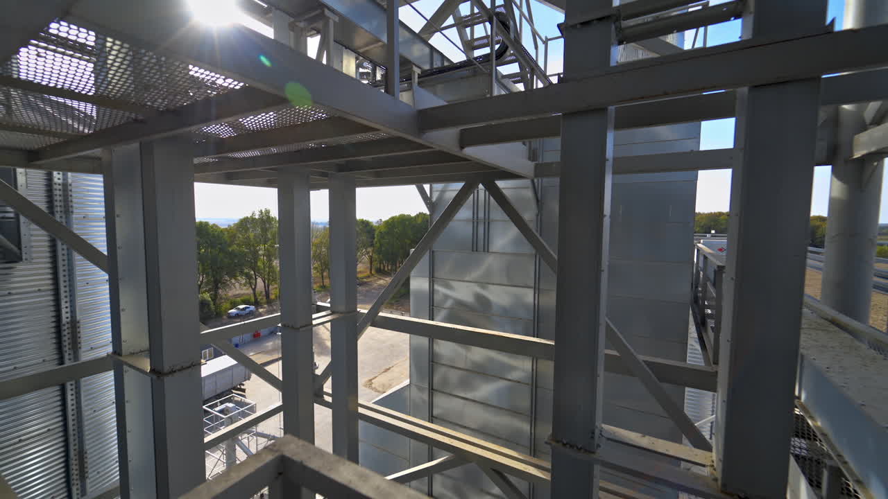 Facility frame construction. Industrial plant at sunlight. Steel equipment of agricultural granary. Exterior of a factory. Close-up.