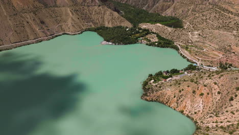 Aerial-View-Of-Iskanderkul-Lake-In-The-Heart-Of-Tajikistan-Mountains---drone-shot