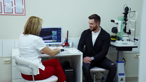 ophthalmologist talking about treatment. doctor talking to patient about eye examination