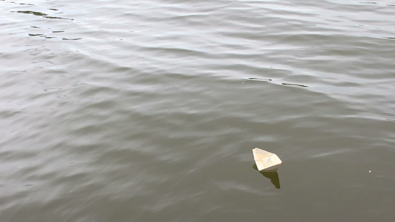 Active Leisure For Children. Boy play in paper ship in water puddel