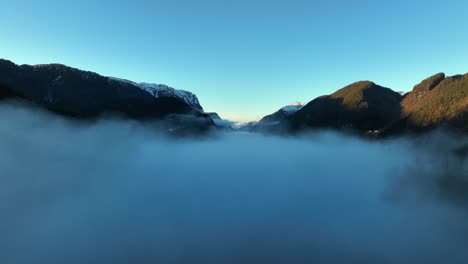 morning haze at sunrise with veafjord in background, norway aerial