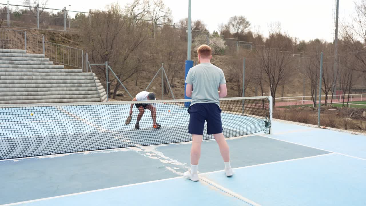 Two Men Playing and Celebrating During a Pickleball Game