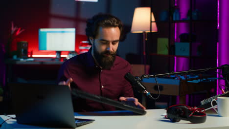 man in studio reviewing gaming keyboard received from sponsoring brand