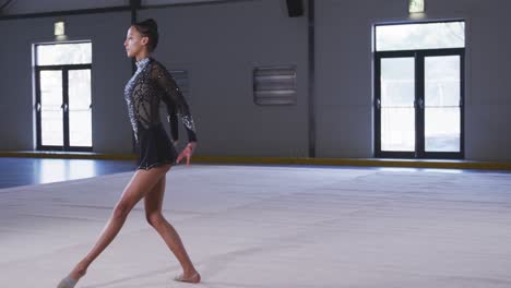 Teenage-female-gymnast-performing-at-sports-hall