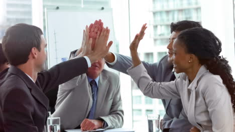 colleagues giving highfive in slow motion