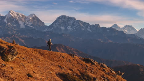 drone shot of male tourist walking ridges of nepal everest mountain range at pikeypeak 4k