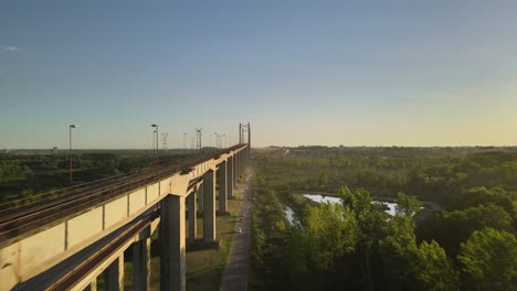 dolly en vuelo junto a zarate brazo largo complejo vial y ferroviario puente atirantado entre campos verdes a la hora dorada, entre rios, argentina
