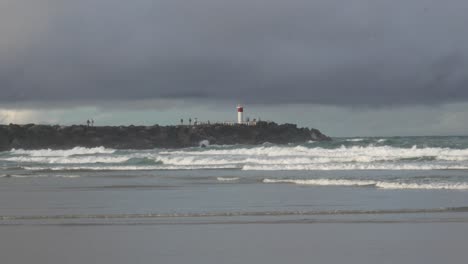 lighthouse spit gold coast australia, ocean waves, cloudy storm clouds