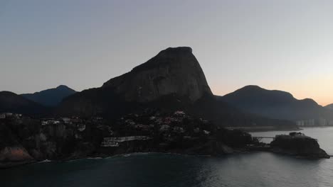 Luftanflug-Auf-Den-Strand-Von-Joatinga-Mit-Dem-Berg-Givea-Im-Hintergrund-Und-Dem-Costa-Brava-Club-Auf-Einer-Insel-Im-Vordergrund-Im-Morgengrauen-In-Rio-De-Janeiro