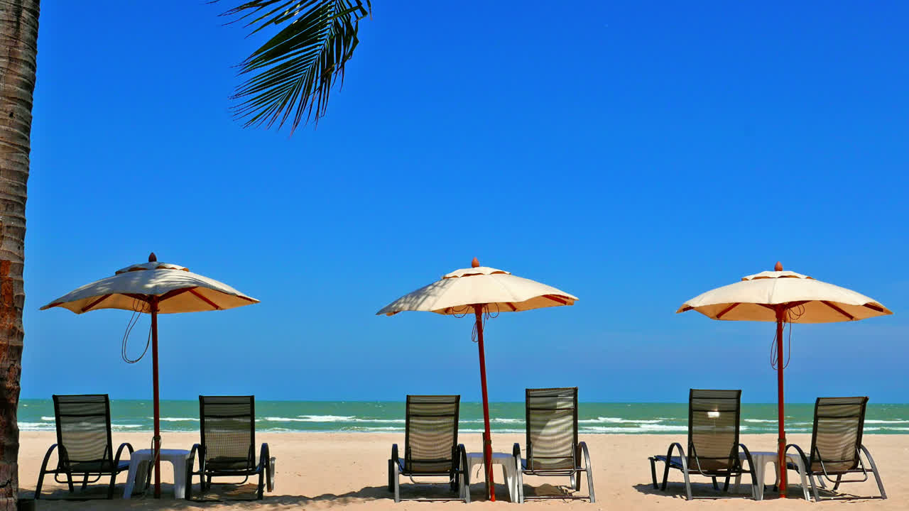 Ombrellone e sedia in spiaggia con paesaggio marino per viaggi.