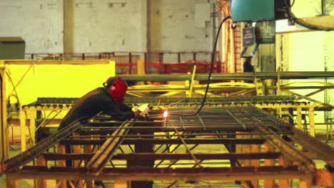 worker welding steel construction in protective mask. heavy industry workman