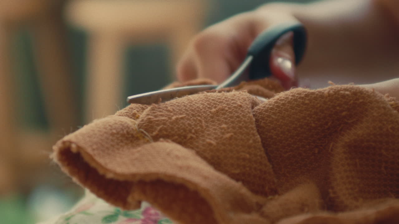 Woman cutting fabric with scissors