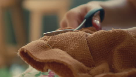 woman cutting fabric with scissors