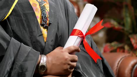 person holding a graduation diploma