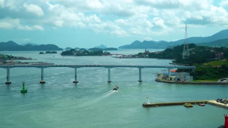 picturesque view of singeojedaegyo bridge joins geojedo island in south korea to the mainland - cumulus clouds drift overhead