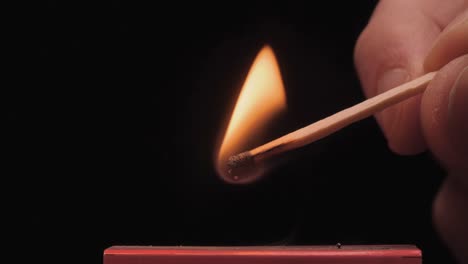 burning match on a black background