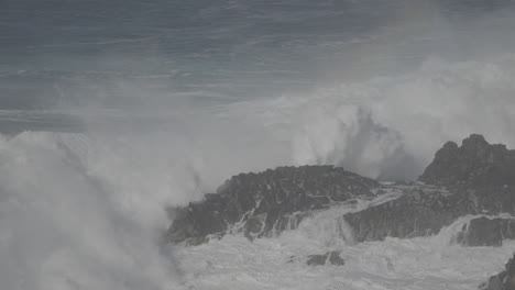 powerful waves crashing against rocks