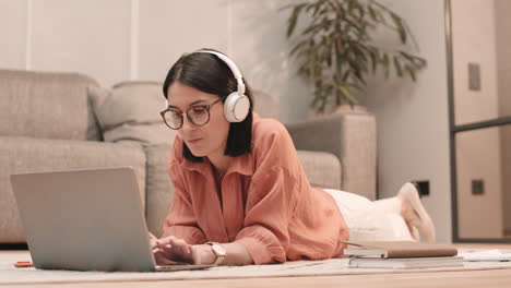 woman in headphones using portable computer
