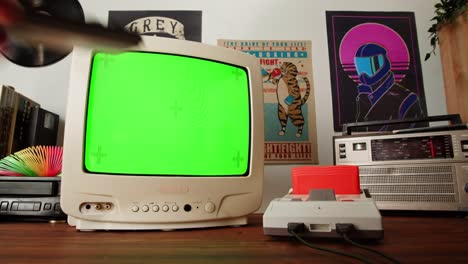 retro gaming setup with green screen tv