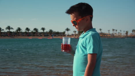 attractive girl and upset boy in sunglasses spending time at coastline.